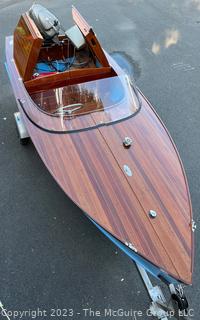 14' Restored 1952 Chris-Craft Classic Wooden Kit Runabout Boat With 1957 Mercury Mark 55E Outboard Motor And Mastercraft Trailer. According to consignor, "Winner of the Prestigious Best Outboard Boat Award at the 26th annual Antique and Classic Boat Society Chesapeake Bay Chapter Antique and Classic Boat Festival 2014. Originally assembled by Norman W. Bailey of Newmarket N.J., the boat has been renovated with expert craftsmanship and the finest materials and hardware available.  Stripped the the hull bare, replaced with Sepele Mahogany. All original wood sealed with CPES epoxy (inside and out) and joints secured with West Systems. Sikaflex adhesive sealant caulk on deck to match wood color. 3 coats of Pettit - Bikini Blue on hull and 7 coats of Z-Spar on deck. Matching exterior grade latex paint on hull interior to help wood breath and dampness evaporate. Flush cleats and electrical switching by Attwood and Cole Hersee Co.-U.S.A.. (see more below)