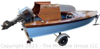 14' Restored 1952 Chris-Craft Classic Wooden Kit Runabout Boat With 1957 Mercury Mark 55E Outboard Motor And Mastercraft Trailer. According to consignor, "Winner of the Prestigious Best Outboard Boat Award at the 26th annual Antique and Classic Boat Society Chesapeake Bay Chapter Antique and Classic Boat Festival 2014. Originally assembled by Norman W. Bailey of Newmarket N.J., the boat has been renovated with expert craftsmanship and the finest materials and hardware available.  Stripped the the hull bare, replaced with Sepele Mahogany. All original wood sealed with CPES epoxy (inside and out) and joints secured with West Systems. Sikaflex adhesive sealant caulk on deck to match wood color. 3 coats of Pettit - Bikini Blue on hull and 7 coats of Z-Spar on deck. Matching exterior grade latex paint on hull interior to help wood breath and dampness evaporate. Flush cleats and electrical switching by Attwood and Cole Hersee Co.-U.S.A.. (see more below)