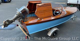 14' Restored 1952 Chris-Craft Classic Wooden Kit Runabout Boat With 1957 Mercury Mark 55E Outboard Motor And Mastercraft Trailer. According to consignor, "Winner of the Prestigious Best Outboard Boat Award at the 26th annual Antique and Classic Boat Society Chesapeake Bay Chapter Antique and Classic Boat Festival 2014. Originally assembled by Norman W. Bailey of Newmarket N.J., the boat has been renovated with expert craftsmanship and the finest materials and hardware available.  Stripped the the hull bare, replaced with Sepele Mahogany. All original wood sealed with CPES epoxy (inside and out) and joints secured with West Systems. Sikaflex adhesive sealant caulk on deck to match wood color. 3 coats of Pettit - Bikini Blue on hull and 7 coats of Z-Spar on deck. Matching exterior grade latex paint on hull interior to help wood breath and dampness evaporate. Flush cleats and electrical switching by Attwood and Cole Hersee Co.-U.S.A.. (see more below)