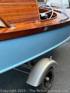 14' Restored 1952 Chris-Craft Classic Wooden Kit Runabout Boat With 1957 Mercury Mark 55E Outboard Motor And Mastercraft Trailer. According to consignor, "Winner of the Prestigious Best Outboard Boat Award at the 26th annual Antique and Classic Boat Society Chesapeake Bay Chapter Antique and Classic Boat Festival 2014. Originally assembled by Norman W. Bailey of Newmarket N.J., the boat has been renovated with expert craftsmanship and the finest materials and hardware available.  Stripped the the hull bare, replaced with Sepele Mahogany. All original wood sealed with CPES epoxy (inside and out) and joints secured with West Systems. Sikaflex adhesive sealant caulk on deck to match wood color. 3 coats of Pettit - Bikini Blue on hull and 7 coats of Z-Spar on deck. Matching exterior grade latex paint on hull interior to help wood breath and dampness evaporate. Flush cleats and electrical switching by Attwood and Cole Hersee Co.-U.S.A.. (see more below)