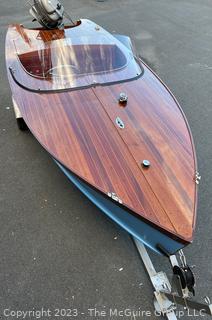 14' Restored 1952 Chris-Craft Classic Wooden Kit Runabout Boat With 1957 Mercury Mark 55E Outboard Motor And Mastercraft Trailer. According to consignor, "Winner of the Prestigious Best Outboard Boat Award at the 26th annual Antique and Classic Boat Society Chesapeake Bay Chapter Antique and Classic Boat Festival 2014. Originally assembled by Norman W. Bailey of Newmarket N.J., the boat has been renovated with expert craftsmanship and the finest materials and hardware available.  Stripped the the hull bare, replaced with Sepele Mahogany. All original wood sealed with CPES epoxy (inside and out) and joints secured with West Systems. Sikaflex adhesive sealant caulk on deck to match wood color. 3 coats of Pettit - Bikini Blue on hull and 7 coats of Z-Spar on deck. Matching exterior grade latex paint on hull interior to help wood breath and dampness evaporate. Flush cleats and electrical switching by Attwood and Cole Hersee Co.-U.S.A.. (see more below)