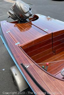 14' Restored 1952 Chris-Craft Classic Wooden Kit Runabout Boat With 1957 Mercury Mark 55E Outboard Motor And Mastercraft Trailer. According to consignor, "Winner of the Prestigious Best Outboard Boat Award at the 26th annual Antique and Classic Boat Society Chesapeake Bay Chapter Antique and Classic Boat Festival 2014. Originally assembled by Norman W. Bailey of Newmarket N.J., the boat has been renovated with expert craftsmanship and the finest materials and hardware available.  Stripped the the hull bare, replaced with Sepele Mahogany. All original wood sealed with CPES epoxy (inside and out) and joints secured with West Systems. Sikaflex adhesive sealant caulk on deck to match wood color. 3 coats of Pettit - Bikini Blue on hull and 7 coats of Z-Spar on deck. Matching exterior grade latex paint on hull interior to help wood breath and dampness evaporate. Flush cleats and electrical switching by Attwood and Cole Hersee Co.-U.S.A.. (see more below)