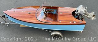 14' Restored 1952 Chris-Craft Classic Wooden Kit Runabout Boat With 1957 Mercury Mark 55E Outboard Motor And Mastercraft Trailer. According to consignor, "Winner of the Prestigious Best Outboard Boat Award at the 26th annual Antique and Classic Boat Society Chesapeake Bay Chapter Antique and Classic Boat Festival 2014. Originally assembled by Norman W. Bailey of Newmarket N.J., the boat has been renovated with expert craftsmanship and the finest materials and hardware available.  Stripped the the hull bare, replaced with Sepele Mahogany. All original wood sealed with CPES epoxy (inside and out) and joints secured with West Systems. Sikaflex adhesive sealant caulk on deck to match wood color. 3 coats of Pettit - Bikini Blue on hull and 7 coats of Z-Spar on deck. Matching exterior grade latex paint on hull interior to help wood breath and dampness evaporate. Flush cleats and electrical switching by Attwood and Cole Hersee Co.-U.S.A.. (see more below)