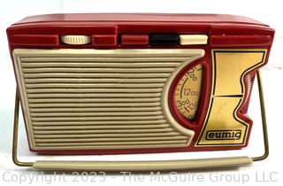 Red Eumig (Electricity and Metallwaren-Industrie-Gesellschaft) Transistor Radio, Made in Vienna. Measures 3 x 6"