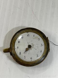 Small clock movement. Maker engraved, but not legible