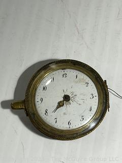 Small clock movement. Maker engraved, but not legible