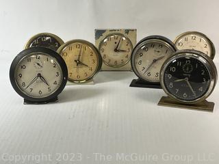 Seven (7) Travel Wind Up Alarm Clocks