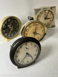 Seven (7) Travel Wind Up Alarm Clocks