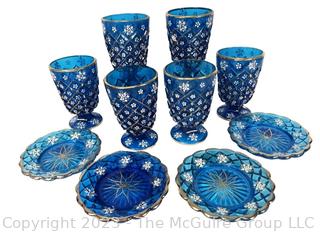 Set of Blue Depression Glass Plates and Goblets Decorated With Flowers And Gold