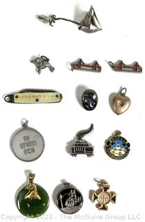 Twelve (12) Charms or Pendants and One Sterling Sailboat Pin