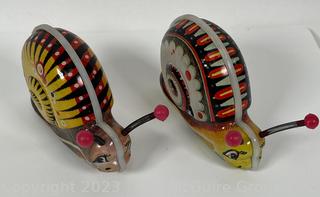 Two (2) Wind Up Snail Tin Toy Makes