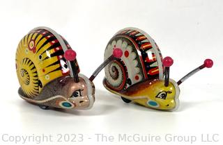 Two (2) Wind Up Snail Tin Toy Makes