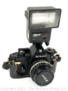 Nikon EM Film Camera with (2) Series E Lenses: 28MM 1:1.28 and 50MM 1:1.8 plus Flash Attachment