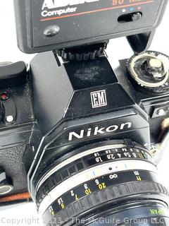 Nikon EM Film Camera with (2) Series E Lenses: 28MM 1:1.28 and 50MM 1:1.8 plus Flash Attachment