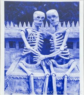 Framed Under Glass Altered Photo of Skeletons on Bench. 19 x 23"