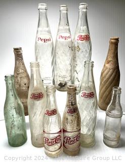 Collection of Clear Soda Glass Bottles Including Pepsi