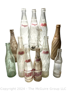 Collection of Clear Soda Glass Bottles Including Pepsi