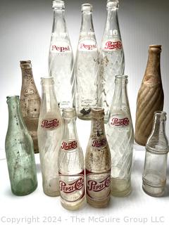 Collection of Clear Soda Glass Bottles Including Pepsi