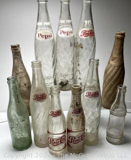 Collection of Clear Soda Glass Bottles Including Pepsi