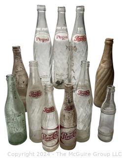 Collection of Clear Soda Glass Bottles Including Pepsi