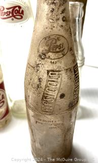 Collection of Clear Soda Glass Bottles Including Pepsi