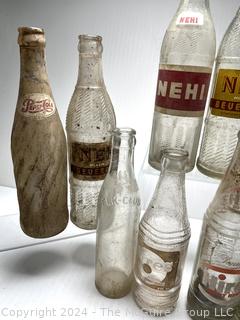 Collection of Clear Soda Glass Bottles Including Nehi