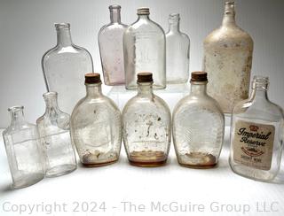 Group of Clear Whiskey Bottles and Flasks