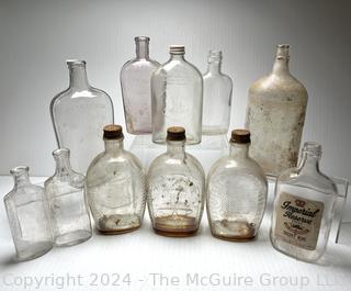 Group of Clear Whiskey Bottles and Flasks