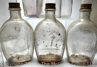 Group of Clear Whiskey Bottles and Flasks