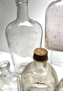 Group of Clear Whiskey Bottles and Flasks