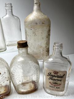 Group of Clear Whiskey Bottles and Flasks