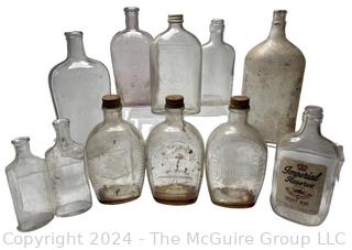 Group of Clear Whiskey Bottles and Flasks