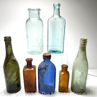 Seven (7) Color Glass Bottles