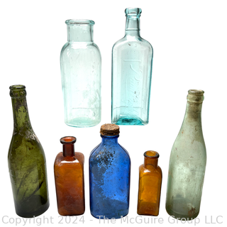 Seven (7) Color Glass Bottles