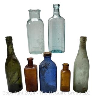 Seven (7) Color Glass Bottles