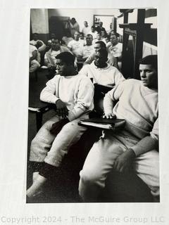 Vintage photos of the early Philadelphia Eagles football coaches and players reviewing plays and video.