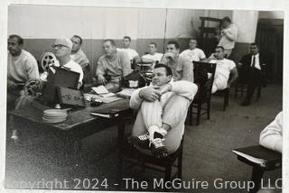 Vintage photos of the early Philadelphia Eagles football coaches and players reviewing plays and video.