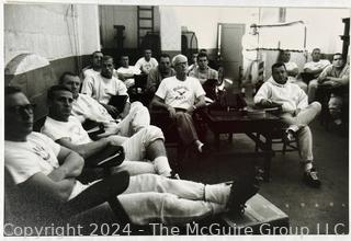 Vintage photos of the early Philadelphia Eagles football coaches and players reviewing plays and video.