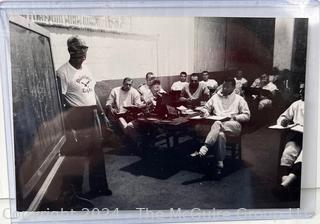 Vintage photos of the early Philadelphia Eagles football coaches and players reviewing plays and video.