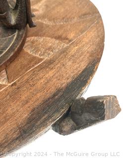 Carved Wood Tripod Table From Zimbabwe with African Wooden Disc With Six Men Seated.