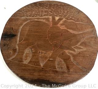 Carved Wood Tripod Table From Zimbabwe with African Wooden Disc With Six Men Seated.