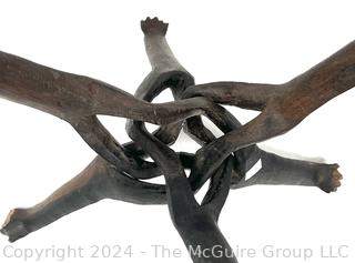 Carved Wood Tripod Table From Zimbabwe with African Wooden Disc With Six Men Seated.