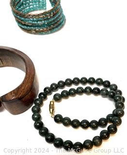 Jewelry Including Carved Wood Horse Bracelet, Beaded Bracelet, Green Stone Bead Necklace and Amber Color Bead Necklace