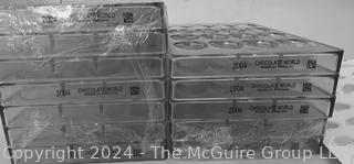 Twelve (12) Chocolate World Polycarbonate Molds #2004 and Four (4) Silicon Mat Mold Trays