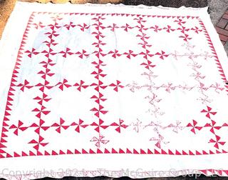 Vintage Hand Stitched Red and White Flour Sack Quilt in the Pinwheel Pattern. Some damage.  80" square 