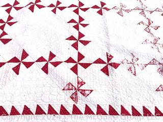 Vintage Hand Stitched Red and White Flour Sack Quilt in the Pinwheel Pattern. Some damage.  80" square 