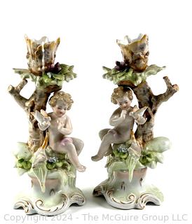 Pair of Cherub Arnart Porcelain Hand Painted Rococo Style Candlestick Holders.  8 1/2" tall.