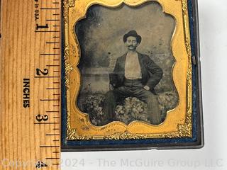 Sixth Plate Daguerreotype Photograph of Man in Hat in Ornate Victorian Gutta Percha Union Case with Velvet Surround. Measures 2.5 x 3"