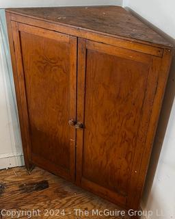 Primitive Pine Two Door Corner Cabinet. Measures 31.5w x 22d x 42.5h"