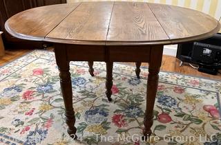 Five (5) Turned Legged Primitive Oak Drop Leaf Table. Measures 53w x 30h"